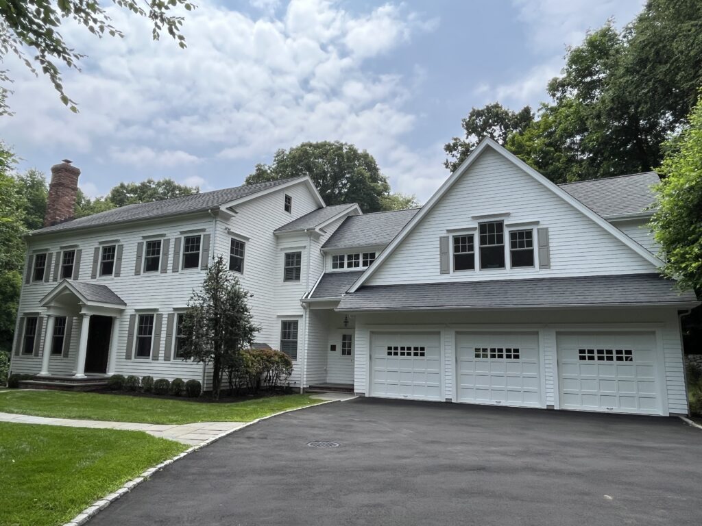 Exterior house painting project in Weston CT with bright white siding and classic curb appeal